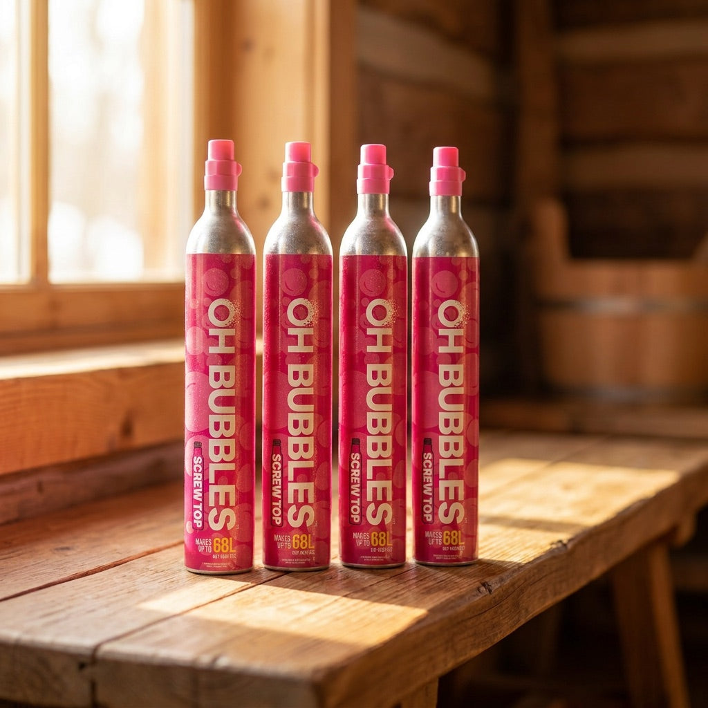 A row of freshly refilled pink OH Bubbles CO2 cylinders on a sunlit bench