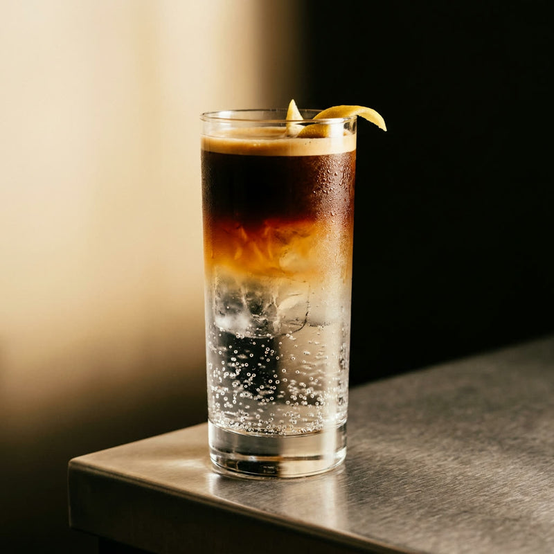 Espresso tonic over ice with a lemon twist