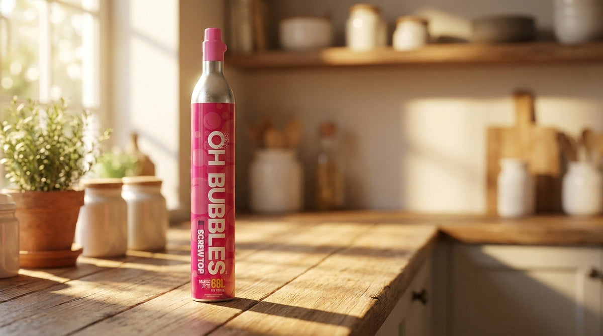 An OH Bubbles screw-top cylinder standing on a sunlit wooden kitchen bench